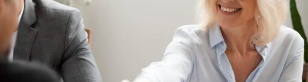 Smiling Attractive Mature Businesswoman Handshaking Businessman